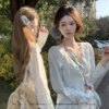 Teenage girl hugging flower cut-out floral knit cardigan