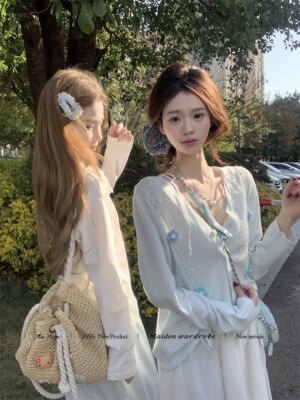 Teenage girl hugging flower cut-out floral knit cardigan