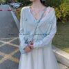 Teenage girl hugging flower cut-out floral knit cardigan