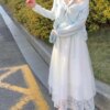 Teenage girl hugging flower cut-out floral knit cardigan