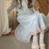Teenage girl hugging flower cut-out floral knit cardigan